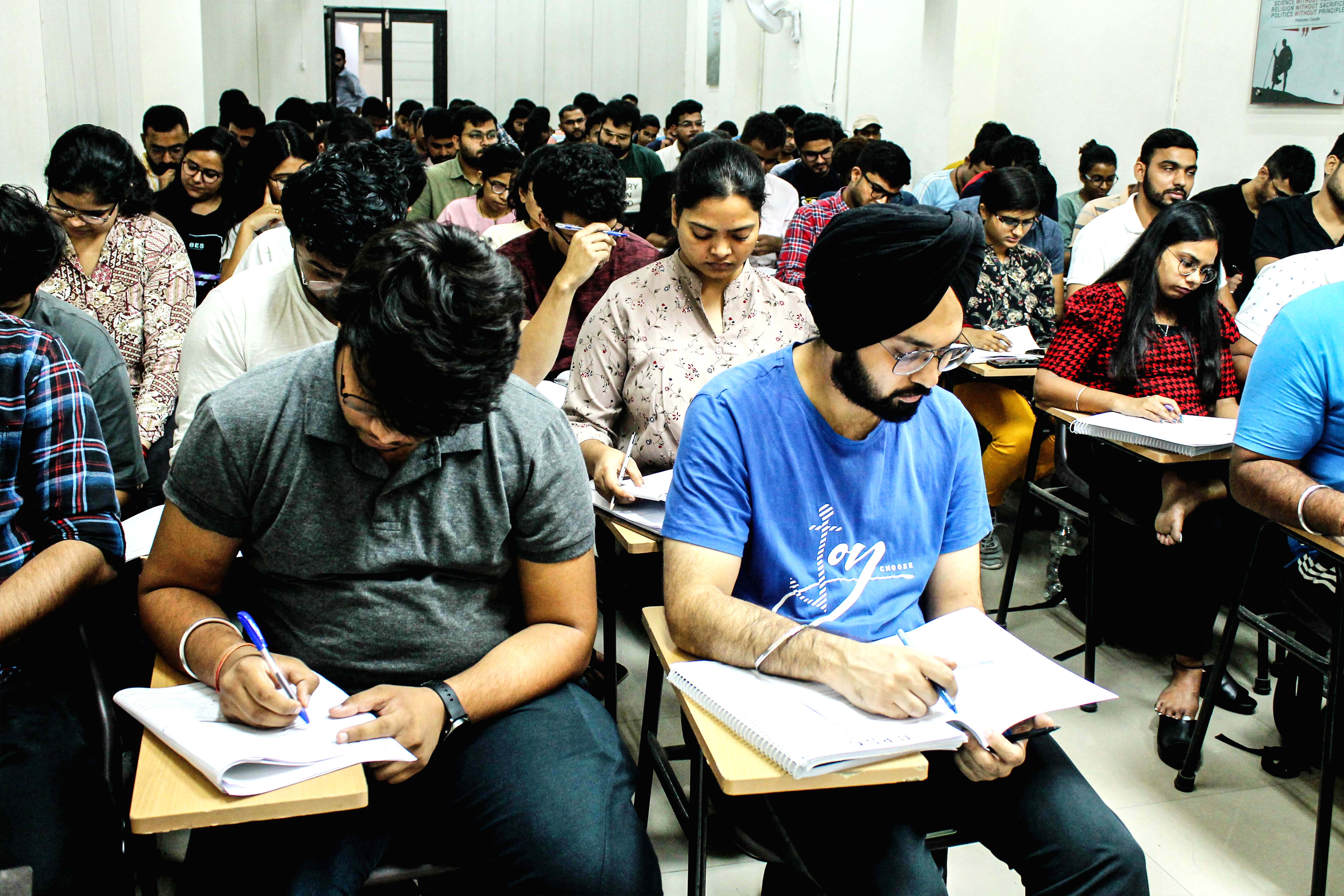 Students writing in a competitive exam preparation class
